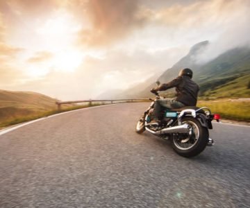 Motorcycle driver riding in Dolomite pass, Italy, south Europe.